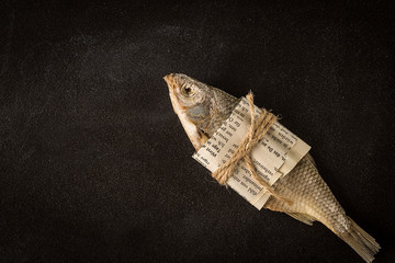 Fototapeta premium Dried fish on a dark background. Top view, Flat lay.