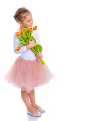 Little girl with a bouquet of tulips.