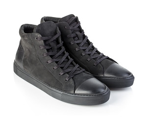 Pair of new black sneakers isolated on white background