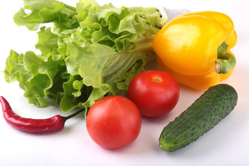 Assorted vegetables, fresh bell pepper, tomato, chilli pepper, cucumber and lettuce isolated on white background. Selective focus.