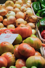 Fresh tomatoes and onions ready for selling at the local market bench. Florence, Italy