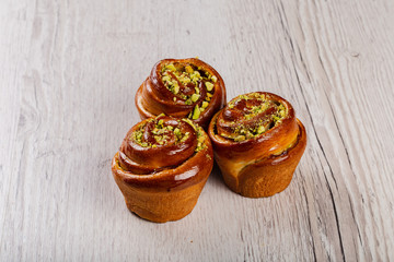 Ruddy fresh beautiful buns on a wooden background.