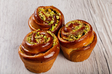 Ruddy fresh beautiful buns on a wooden background.