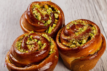 Ruddy fresh beautiful buns on a wooden background.