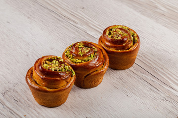 Ruddy fresh beautiful buns on a wooden background.