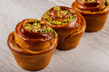 Ruddy fresh beautiful buns on a wooden background.