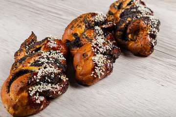 Ruddy fresh beautiful buns on a wooden background.