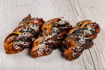 Ruddy fresh beautiful buns on a wooden background.