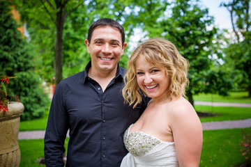 Fototapeta premium Romantic tenderness bride and groom at park. Young lady plus size enjoying moments in summer time. Beautiful bride posing with groom in her wedding day, pretty girl in a wedding dress 