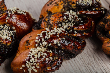 Ruddy fresh beautiful buns on a wooden background.