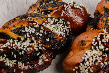 Ruddy fresh beautiful buns on a wooden background.