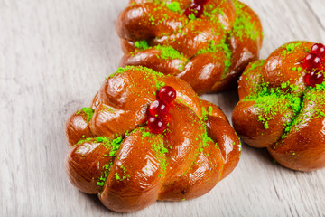 Ruddy fresh beautiful buns on a wooden background.
