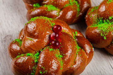 Ruddy fresh beautiful buns on a wooden background.