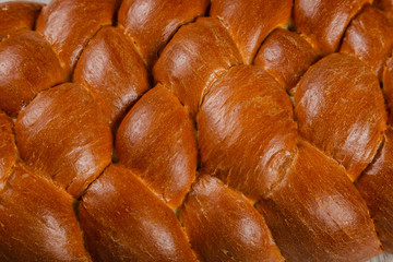 Freshly baked bread on a wooden background.