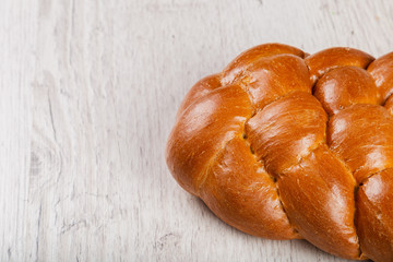 Freshly baked bread on a wooden background.