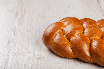 Freshly baked bread on a wooden background.