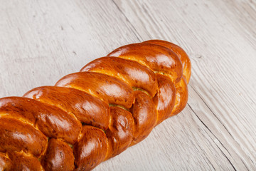 Freshly baked bread on a wooden background.