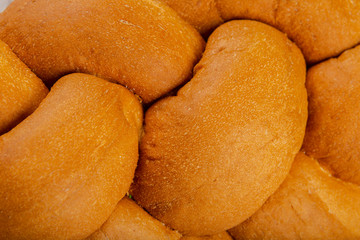 Freshly baked bread on a wooden background.