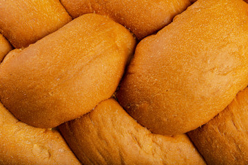 Freshly baked bread on a wooden background.