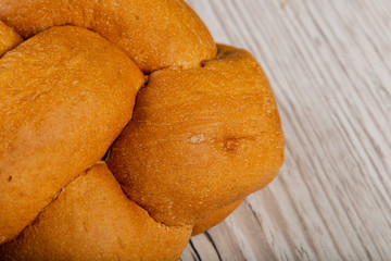 Freshly baked bread on a wooden background.