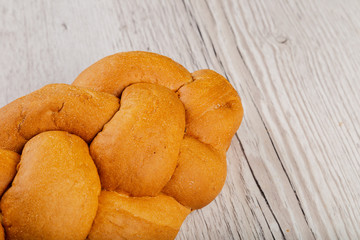 Freshly baked bread on a wooden background.
