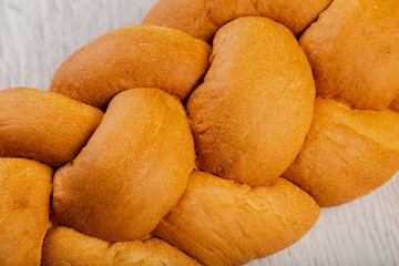 Freshly baked bread on a wooden background.