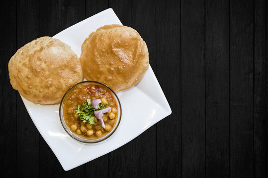 Delicious Chole Bhature ( spicy white Chick Peas) Indian Punjabi Cuisine served in Glass bowl in India