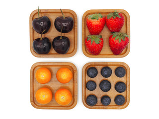 Fototapeta premium Fresh summer fruits, Cherry, strawberry, cape gooseberry and blueberry in wooden plate isolated on white background.