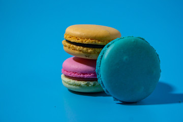Macarons on cyan background clouseup.