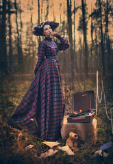 Lonely girl in the woods with a gramophone