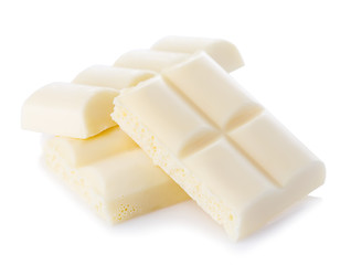 White chocolate pieces close-up isolated on a white background.