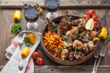 Spicy baked chicken with sausages, sage and lemon. Top view.