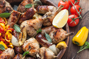 Close view of baked chicken in ceramic pot with vegs and wine