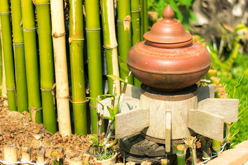 Clay pot used for storage water and decorated in the garden.