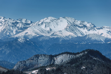 Landscape of snow-capped peaks of the rocky mountains in Sunny weather. The concept of nature and travel.