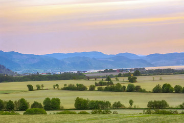 Obraz premium Agricultural area Oesand, Norway, at warm spring sunset 
