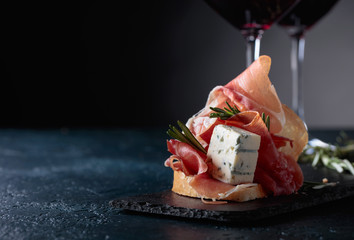 Sandwich with prosciutto, blue cheese and rosemary .