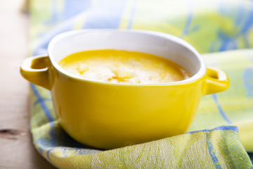 Cheese soup in a yellow plate