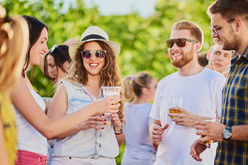 Group of people dancing and having a good time at the outdoor party/music festival 