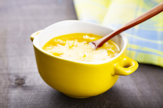 Cheese soup in a yellow plate