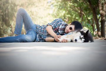 Siberian husky dog sleep on a cement floor with the owner.