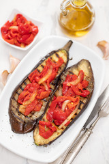 grilled eggplant with red pepper on white dish