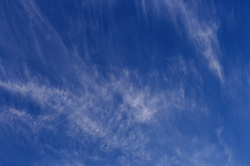 beautiful blue sky with white feathery clouds as a natural background