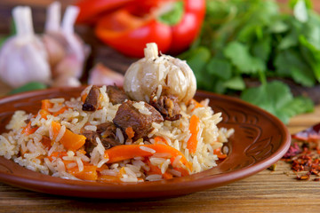 Uzbek pilaf on wooden background