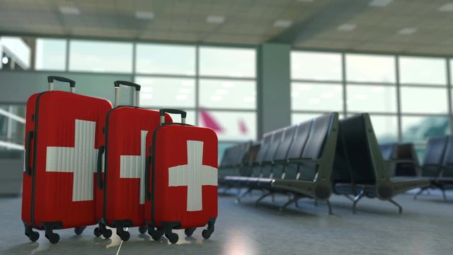 Travel suitcases featuring flag of Switzerland. Canadian tourism conceptual animation