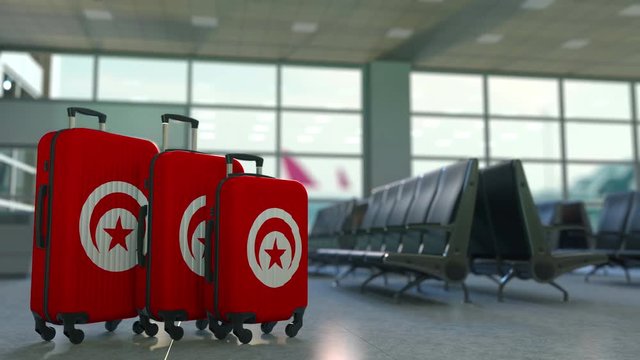 Travel suitcases featuring flag of Tunisia. Tunisian tourism conceptual animation
