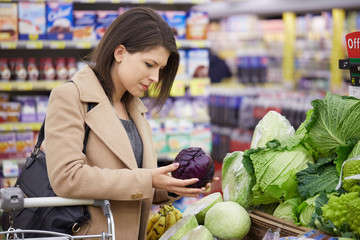 pretty woman buy fruits and vegetables at supermarket