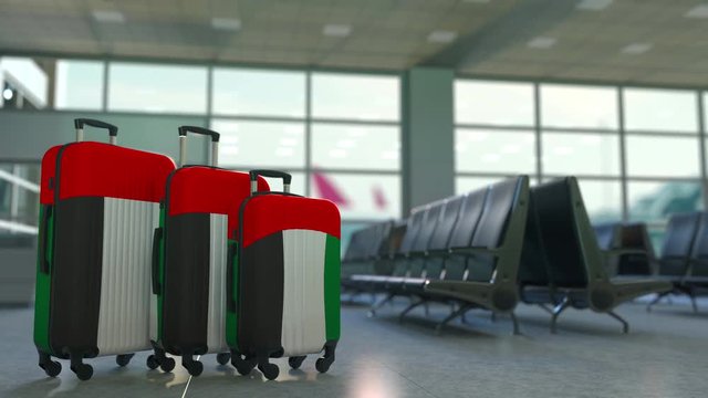 Travel suitcases featuring flag of the United Arab Emirates. UAE tourism conceptual animation