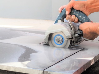 Close up worker use wet sawing machine for cutting marble stone