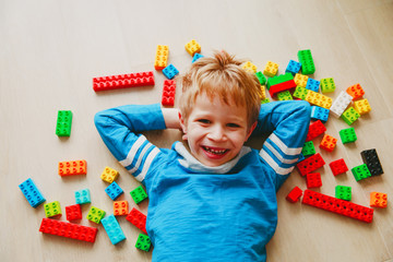 cute little boy love play with plastic blocks
